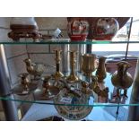A shelf of brassware including Partridge teddy bears candlesticks
