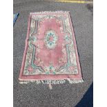 A Pink and White oriental floral pattern rug (166cm x 95cm) Collect only