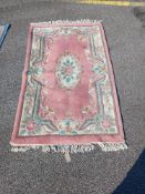 A Pink and White oriental floral pattern rug (166cm x 95cm) Collect only
