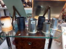 A quantity of tankards including pewter 1977 Ruston gas turbines, Fosters pottery, Kynance Cove