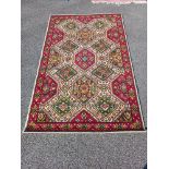 A red and White mid-Eastern Axminster floral pattern rug (183 x 118cm) Collect only