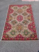 A red and White mid-Eastern Axminster floral pattern rug (183 x 118cm) Collect only