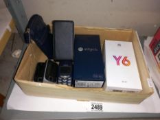 A box of old mobile phones