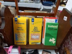 An oak book rack and quantity of vintage maps Collect only