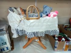 A dolls Moses basket on stand with contents