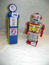 A Plastoy plastic robot money box and a Churchills petrol pump biscuit tin