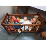 A vintage wooden dolls cot and contents COLLECT ONLY