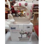 A boxed child's mini sewing machine