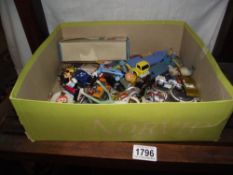 Contents of a toy box including nostalgia badges, Dinky, Matchbox diecast, Coca Cola memorabilia etc