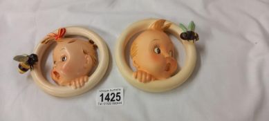 A Goebel Hummel baby boy and baby girl plaques, marked 30 OA and 30/08