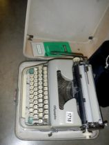 An original cases Olympia SM2 typewriter with paperwork, COLLECT ONLY.