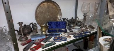 A large shelf of metalware, silver plate tea set, candlesticks & tourist spoons etc. COLLECT ONLY
