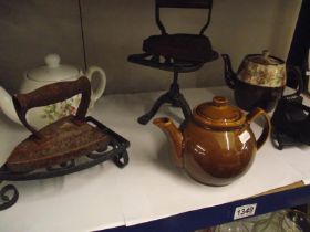 A mixed lot including 3 trivets, 2 flat irons, 3 vintage teapots and a 4lb weight COLLECT ONLY