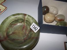 A quantity of polished stone eggs and a marble ashtray