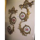 A pair of brass wall decorations with porcelain plaque inserts COLLECT ONLY