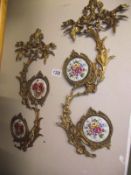 A pair of brass wall decorations with porcelain plaque inserts COLLECT ONLY