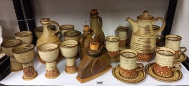 A stoneware studio pottery coffee set with brandy, rum and wine containers COLLECT ONLY