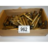 A box of spent brass rifle shells.