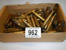 A box of spent brass rifle shells.