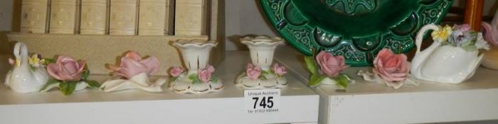 Two Royal Doulton floral swan ornaments and other rose ornaments.