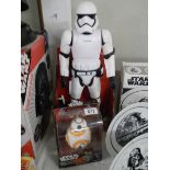 A boxed Star Wars stormtrooper with blaster and a boxed Star Wars BB-8 Droid.