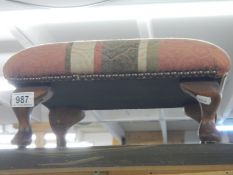 A good footstool on Queen Anne style legs, in good condition.