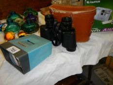 A cased set of binoculars, a cased Fuji film camera and a Boots slide viewer.