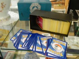 A quantity of Pokemon cards in steam seige box.