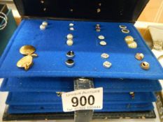 An earring case with assorted earrings.
