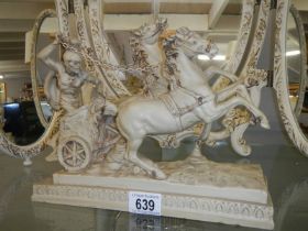 A composite figure of a Roman chariot with horses.