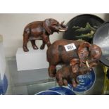 A resin mother and baby elephants and one other.