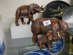 A resin mother and baby elephants and one other.