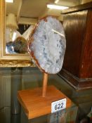 A polished agate geode on stand.