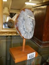 A polished agate geode on stand.