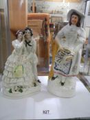 A 19th century Staffordshire figure of a young couple and one other, (one a/f)