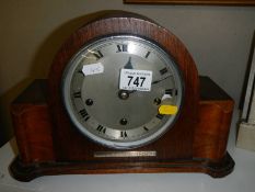A 1938 oak mantel clock (for 51 years service), with key and in working order.