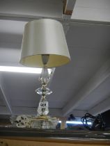 A heavy glass table lamp with shade.