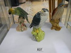 Two Beswick bird figures and a Merlin by Royal Doulton for Whyte and Mackay.