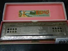 A boxed vintage Hohner Echo harmonica.