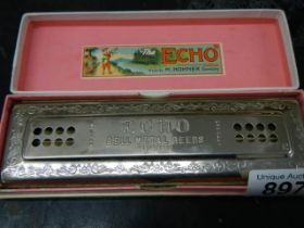 A boxed vintage Hohner Echo harmonica.