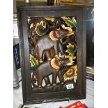 A piece of carved wooden wall art featuring two elephants, 33 x 49 cm, COLLECT ONLY.