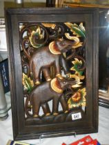 A piece of carved wooden wall art featuring two elephants, 33 x 49 cm, COLLECT ONLY.