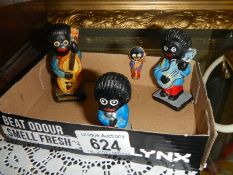 Three vintage Robertsons Jam golly band figures and a pin badge.
