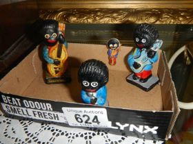 Three vintage Robertsons Jam golly band figures and a pin badge.