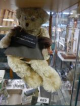 A 'Grandad's Are Antique Little Boys' Teddy bear in a chair.