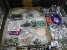 Approximately twenty five necklaces and bracelets.