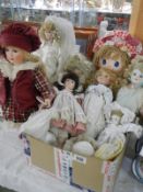 A collection of porcelain dolls and a Hug Me rag doll.