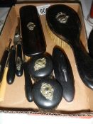 A quantity of vintage ebonised dressing table items including button hook, glove stretchers,