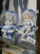 A pair of continental bisque porcelain figures of seated children.