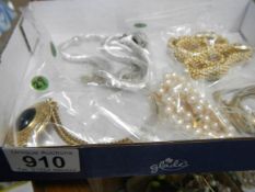 A single strand pearl necklace, a silver coloured twist necklace, a black pendant necklace,